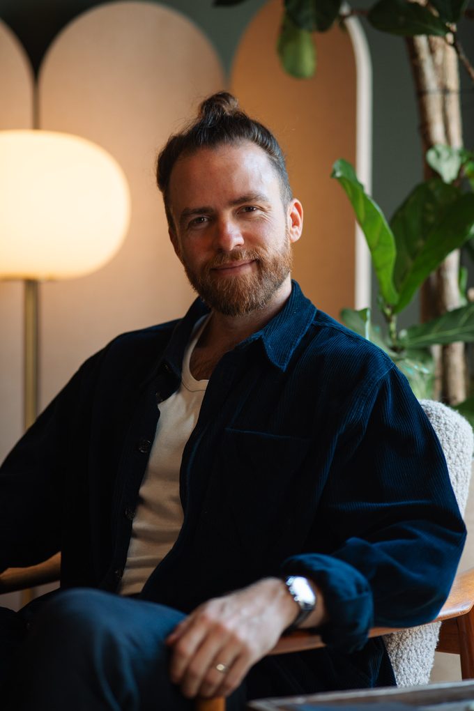 Nicolas Jacobs, Psychotherapeut in Wien, sitzend im Praxisraum